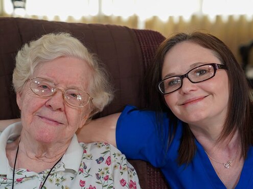 Senior-and-Caregiver-Smiling_1_495x371-min