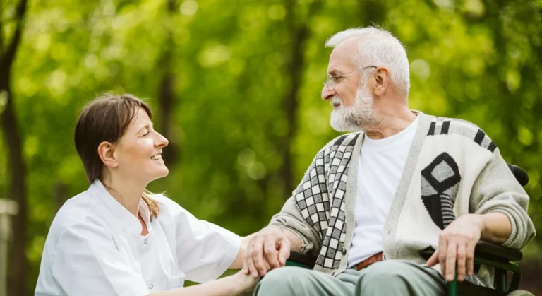 Nurse and patient in the garden of modern senior home with daily care